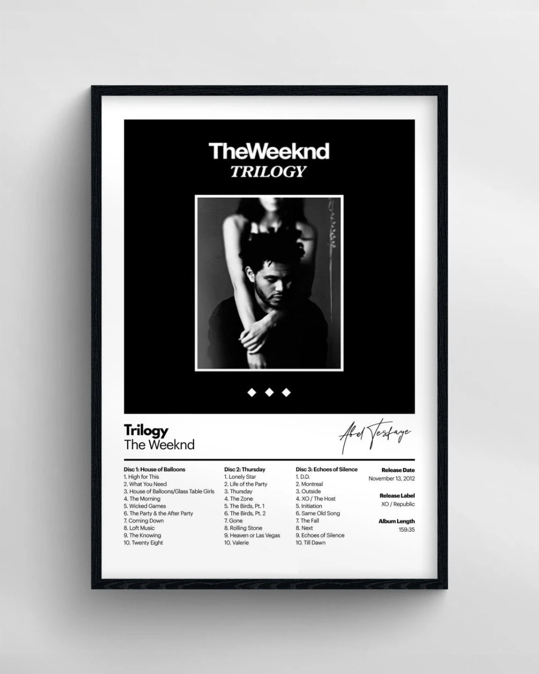 Framed album cover of 'The Weeknd Trilogy' with a black and white photo and tracklist.